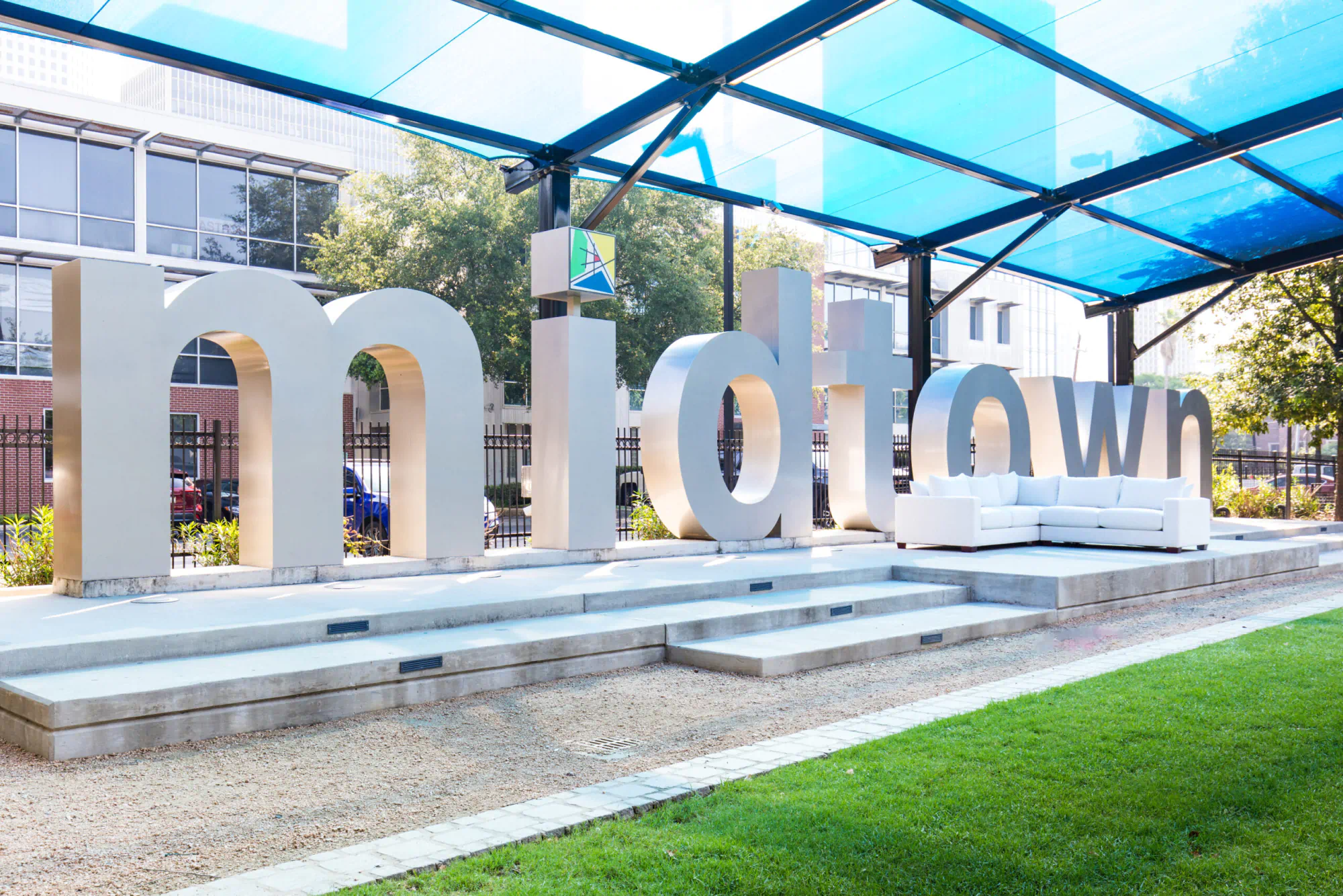 Sculpture of the word Midtown with a couch next to it
